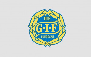 GIF Sundsvalls klubbmärke - en gul krans med texten GIF på en blå platta i mitten och årtalet 1903 ovanför och SUNDSVALL under.